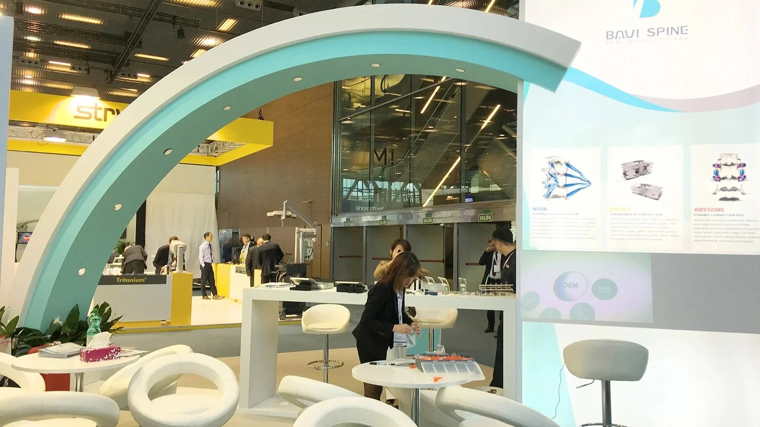 Custom seamless shell scheme exhibition stand with printed graphics and blue lighting at a trade show.